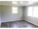 This well-lit room offers a serene ambiance, enhanced by wood grain floors and neutral paint at 411 Rainey Dr, Spring Lake, NC 28390