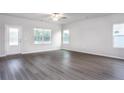 Bright living room featuring wood-look floors, and large windows offering natural light, creating a warm atmosphere at 70 Camp Rock Rd, Lillington, NC 27546