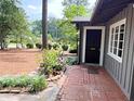 Inviting front entrance with brick walkway, mature landscaping, and stylish home exterior details at 704 Fitts St, Sanford, NC 27330