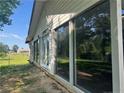 Exterior of home shows siding and a bank of windows along what appears to be an enclosed porch at 71 Marian Ln, Spring Lake, NC 28390