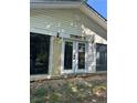 Exterior of home shows siding and a bank of windows and door along what appears to be an enclosed porch at 71 Marian Ln, Spring Lake, NC 28390