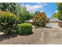 Quaint brick home featuring mature trees and lush landscaping in a serene setting at 764 Turnbury, Sanford, NC 27332