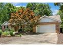 Inviting single-story brick home with a two-car garage and manicured landscaping at 764 Turnbury, Sanford, NC 27332