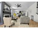 Bright open floor plan living room features a fireplace and herringbone floors that connects to the modern kitchen at 143 Persimmon Tree Dr, Cameron, NC 28326