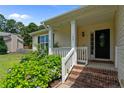 Inviting front porch with brick steps and colorful flowers leading to the front door at 145 Tower Dr, Broadway, NC 27505