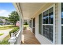 View of the covered front porch with painted wood decking and white railing at 182 Gunner Ct, Broadway, NC 27505