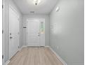 Bright entryway with wood-look floors and white doors at 19 Fifty Caliber Dr, Broadway, NC 27505