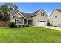 Beautifully landscaped front yard with a charming two-story home at 19 Fifty Caliber Dr, Broadway, NC 27505