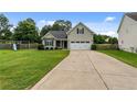 Traditional home with well-kept landscaping, double garage door, and a welcoming front lawn at 19 Fifty Caliber Dr, Broadway, NC 27505