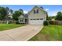 Well-maintained home with a spacious driveway, lush lawn, and a two-car garage at 19 Fifty Caliber Dr, Broadway, NC 27505