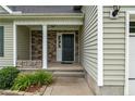 Inviting front porch featuring stone accents and a stylish front door at 19 Fifty Caliber Dr, Broadway, NC 27505