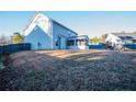 Large backyard with a wooden fence, screened in porch, and plenty of space for outdoor activities at 23 Okame Ct, Spring Lake, NC 28390