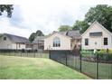 Fenced backyard with well-maintained lawn, patio area, and pergola, ideal for entertaining at 2847 Pickard Rd. Rd, Sanford, NC 27330