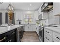 Open kitchen with stainless steel appliances, quartz countertops, and black hardware and accents at 109 Virginia Pine Dr, Cameron, NC 28326