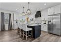 Modern kitchen features a center island with seating, stainless appliances, and pendant lighting at 109 Virginia Pine Dr, Cameron, NC 28326