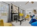 Bright living room showcasing a fireplace with herringbone tile, hardwood floors, and modern decor at 109 Virginia Pine Dr, Cameron, NC 28326