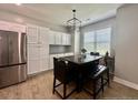 Cozy eat-in kitchen area with ample storage, stainless steel appliances, and a charming view at 110 Citadel St, Cameron, NC 27326