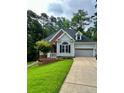 A well-maintained house with a tidy front yard, attached garage, and appealing architectural details at 1397 Colorado Trl, Sanford, NC 27332