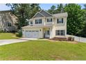 Charming two-story home with a well-manicured lawn and attached two-car garage at 221 Culpepper Rd, Cameron, NC 28326
