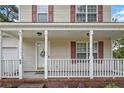 Inviting front porch with white railing and red brick base with trimmed lawn at 69 Ribbon Oak Ct, Sanford, NC 27332