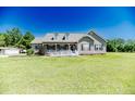 Charming home with covered porch and well-maintained front lawn at 10110 Nc 27 W Hwy, Lillington, NC 27546