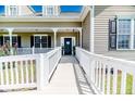 Inviting entrance with white railing leading to the front door and lush landscaping at 10110 Nc 27 W Hwy, Lillington, NC 27546