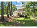 Charming two-story home featuring a covered front porch and attached garage at 1432 Ponderosa Trl, Cameron, NC 28326