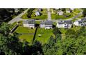 An aerial view of the property showcasing a large, grassy backyard and its proximity to the surrounding neighborhood at 24 Carter Dr, Sanford, NC 27332