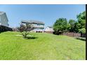 The backyard offers an expansive green lawn perfect for outdoor activities and relaxation at 24 Carter Dr, Sanford, NC 27332