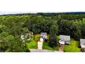 Aerial view of a cozy home nestled among lush green trees and well-maintained lawns at 3229 Seth Dr, Sanford, NC 27330