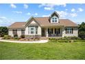 Charming single-story home featuring a cozy front porch and well-manicured lawn at 34 Westchester Ln, Angier, NC 27501
