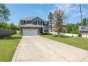 Lovely home with a two-car garage, stone facade, and a long driveway leading to a manicured lawn at 37 Annapolis Rd, Cameron, NC 28326