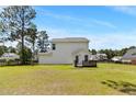 Spacious backyard featuring a green lawn and a wooden deck, perfect for outdoor entertaining at 428 Basket Oak Dr, Bunnlevel, NC 28323