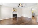 Cozy living room with hardwood floors, a ceiling fan, and a decorative fireplace at 428 Basket Oak Dr, Bunnlevel, NC 28323