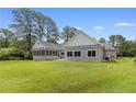 The rear exterior shows a sunroom addition overlooking the well-maintained lawn at 56 Indian Trl, Sanford, NC 27332