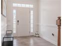 Bright entryway with hardwood floors, white trim, and a bench near the front door at 80 Pedley Pl, Cameron, NC 28326