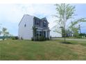 Two-story home featuring neutral siding, well-maintained lawn, and landscaped surroundings at 96 Cutty Way, Lillington, NC 27546