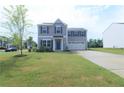 Charming two-story home with a well-manicured lawn and attached two-car garage at 96 Cutty Way, Lillington, NC 27546