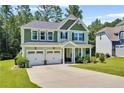 Charming two-story home featuring a two-car garage and a well-manicured lawn at 116 School Side Dr, Spring Lake, NC 28390