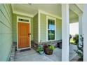 Inviting front porch with colorful potted plants and brick accents offering curb appeal at 116 School Side Dr, Spring Lake, NC 28390