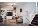 Bright living room with built-in bookshelves, a ceiling fan, and a view of the staircase at 133 Bonnell Ct, Cary, NC 27511