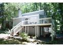 Rear exterior of home with large deck and wooded backdrop and a walkout basement at 133 Bonnell Ct, Cary, NC 27511