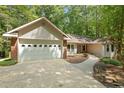 Charming single-story home with a manicured lawn, two-car garage, and lush surrounding trees at 3070 Still Turn, Sanford, NC 27332