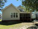 A view of the house, showing the screened porch and backyard at 399 Falling Water Rd, Spring Lake, NC 28390