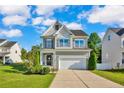 Inviting two-story home with a well-manicured lawn and a classic architectural design at 786 Century Dr, Cameron, NC 28326