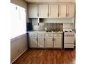 Functional kitchen with light wood cabinetry, a tiled backsplash, modern appliances, and bright natural lighting at 1113 Midland Ter, Durham, NC 27704