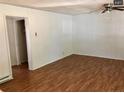 Bright living room featuring wooden flooring, a ceiling fan, and a large closet for storage at 1113 Midland Ter, Durham, NC 27704