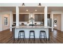 Modern kitchen boasts a large island with seating and stainless steel appliances at 1418 Crawford Dairy Rd, Pittsboro, NC 27312