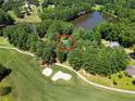 Aerial view of home near a golf course and pond at 185 Tree Cutters, Sanford, NC 27332