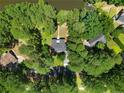 Aerial view showcases a home nestled among trees and waterfront at 185 Tree Cutters, Sanford, NC 27332